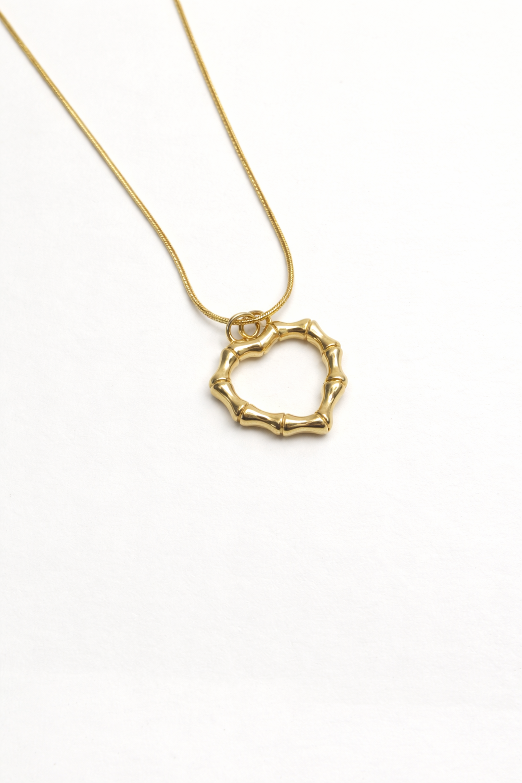 Golden Orbit Pendant with elegant circular design and polished gold finish